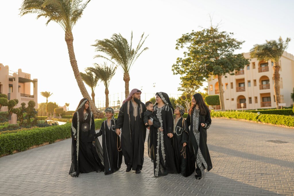 Family posing during a family photoshoot in Sharm El Sheikh on a beach at sunset.