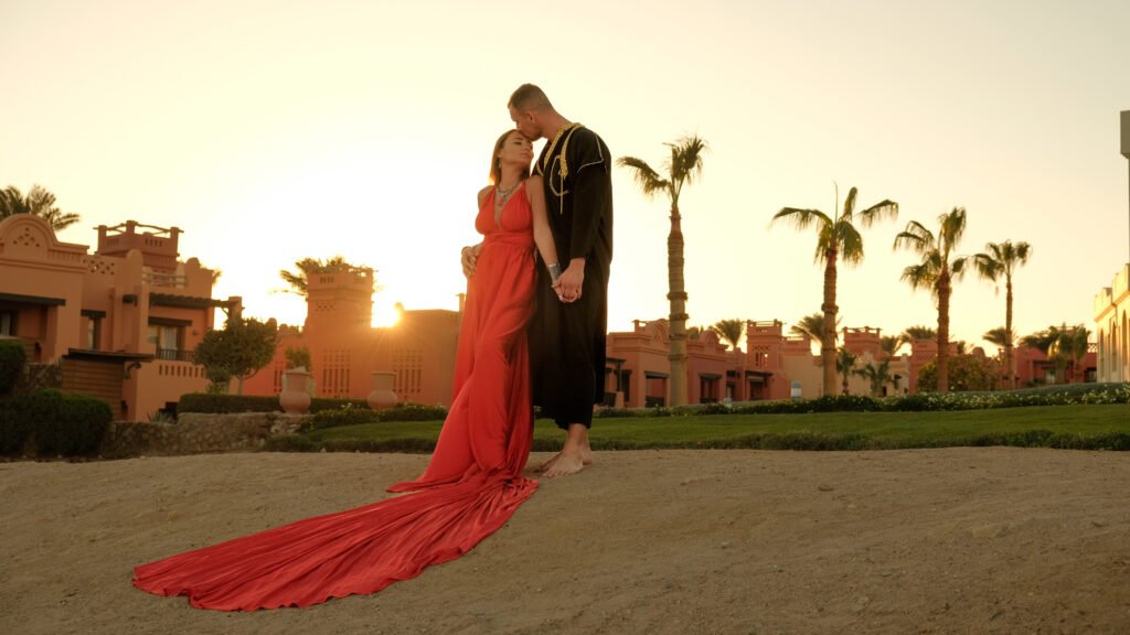 Couple posing during a couples photoshoot in Sharm El Sheikh by the Red Sea at sunset.