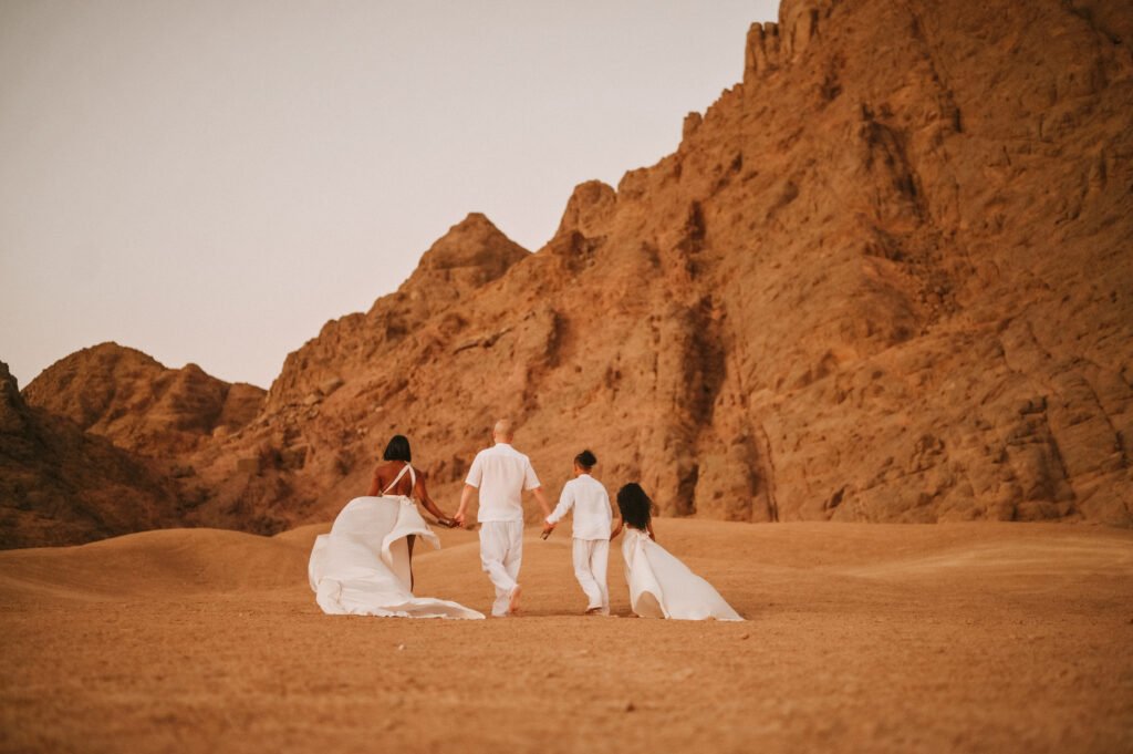 Group posing for Sharm desert photos in dunes.