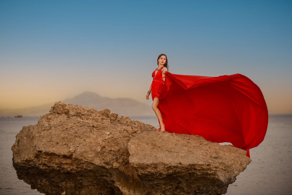 girl posing during a professional photoshoot in Sharm El Sheikh on a beach at sunset.