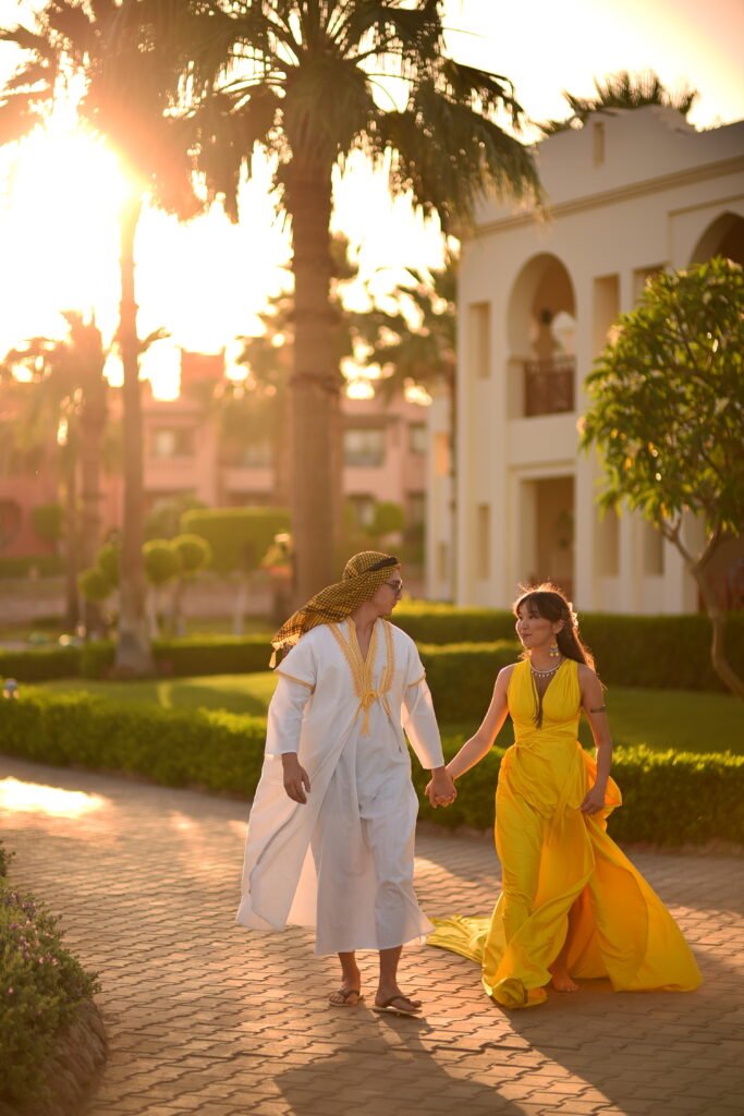 Couple by a pool during a hotel photoshoot in Sharm El Sheikh’s luxury resort at sunset.