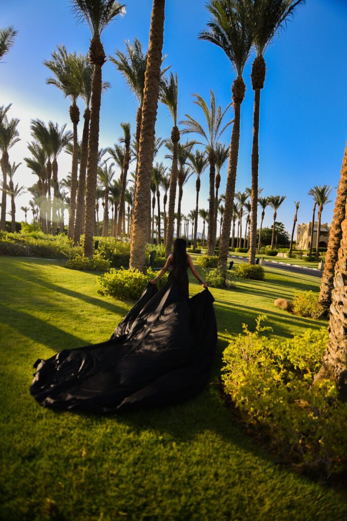 Woman in colorful flying dress posing on Sharm El Sheikh beach during photoshoot